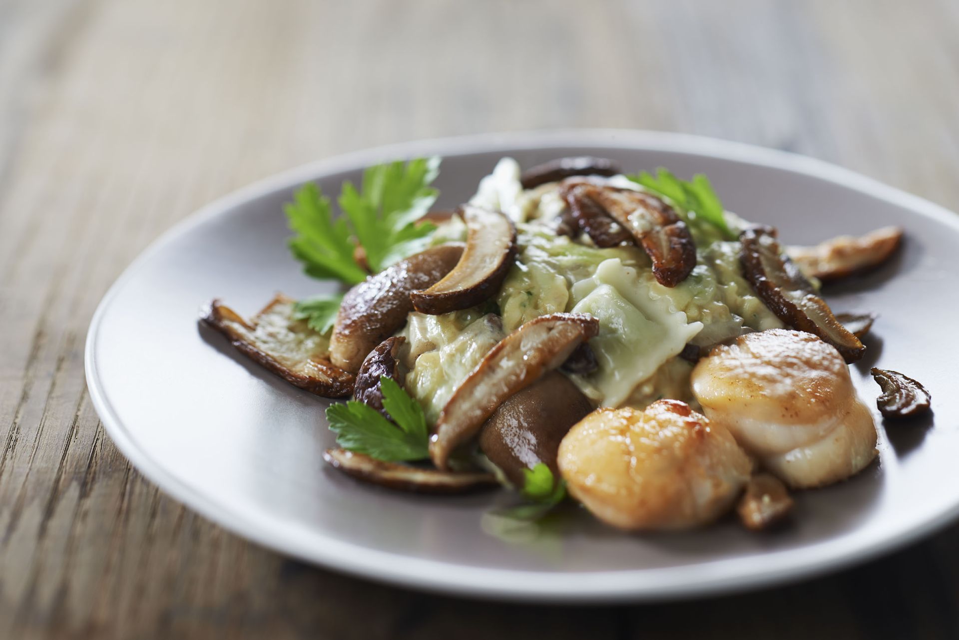 Dome de ravioles du Dauphine aux cepes et noix de St Jacques flambees au Cognac